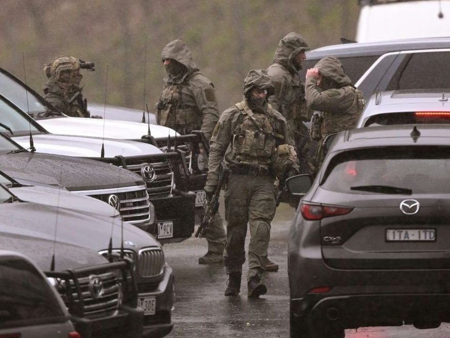 Australian police say their priority is to catch a gunman accused of killing two officers.