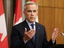Prime Minister Mark Carney speaks at a news conference following a cabinet meeting to discuss both trade negotiations with the United States and the situation in the Middle East, at the National Press Theater in Ottawa, July 30, 2025.