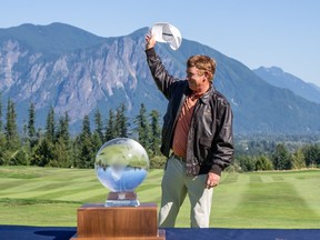 Steve Allan acknowledges fans during a trophy presentation.