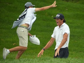 Christo Lamprecht celebrates a golf shot with his caddie.