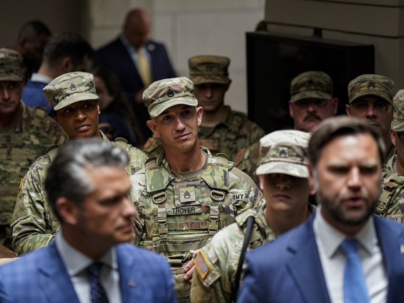 Members of the National Guard listen as Vice-President JD Vance and Defence Secretary Pete Hegseth speak.