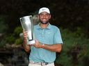 Scottie Scheffler of the United States poses with the tournament trophy after his winning round on the 18th green after the final round of the BMW Championship 2025 at Caves Valley Golf Club on August 17, 2025 in Owings Mills, Maryland.