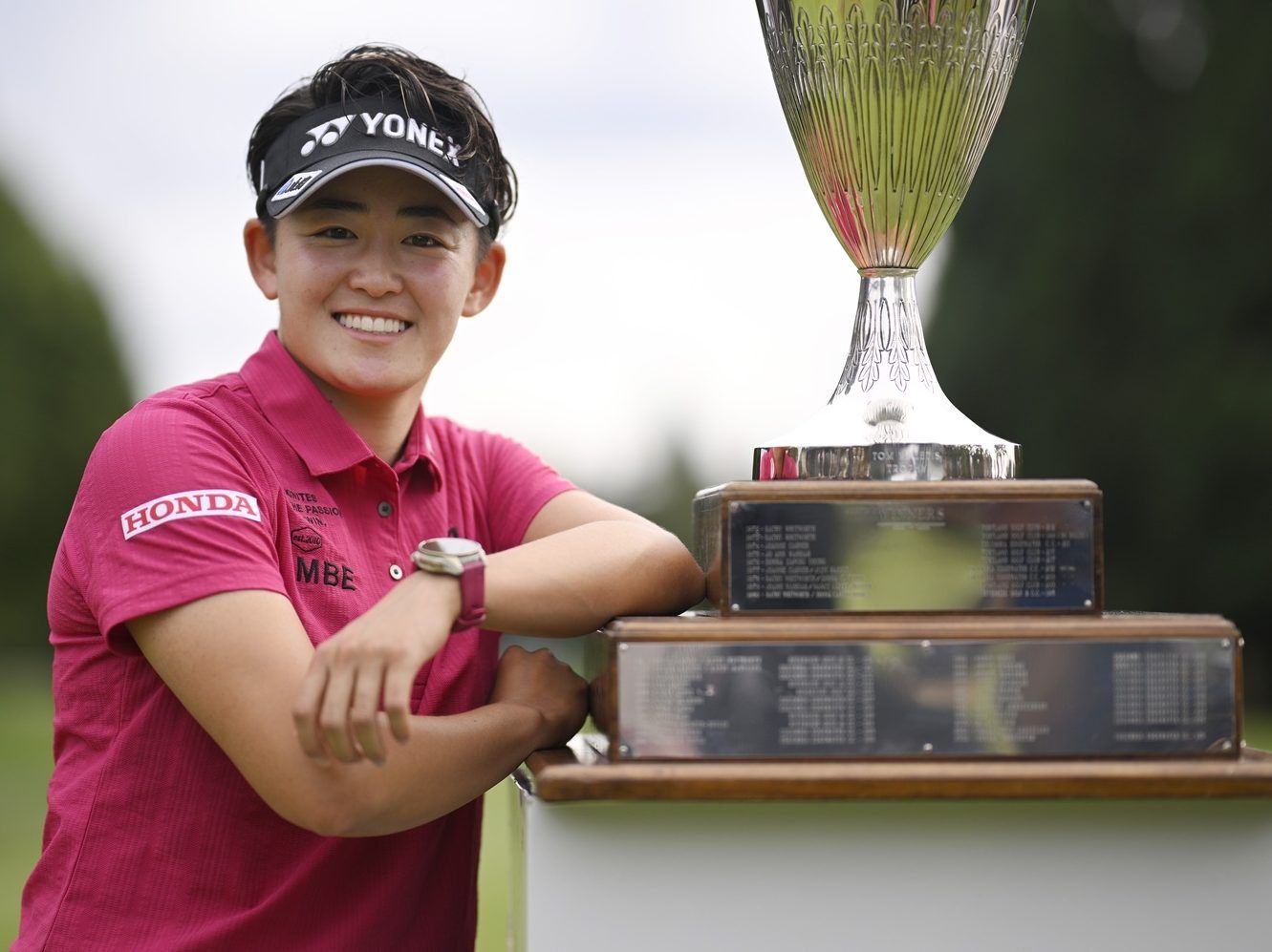 Akie Iwai poses with a golf trophy.