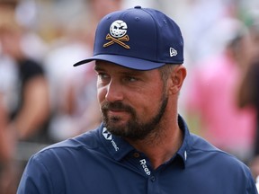 Bryson DeChambeau walks to the driving range.