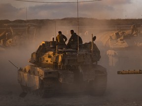 IDF soldiers prepare tanks.