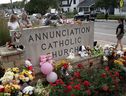 People leave flowers and other mementoes in front of Annunciation Catholic Church, a rapidly growing memorial to the victims of yesterday's shooting on August 28, 2025 in Minneapolis, Minnesota.