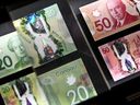 A magnifying glass enlarges the holographic image of Parliament Hill's Peace Tower on a 20 dollar bill issued by the Bank of Canada, shown in a display case at the Bank of Canada Museum in Ottawa, on Wednesday, Sept. 4, 2024.