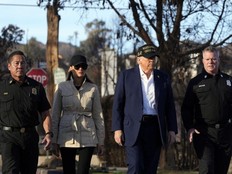 President Donald Trump, center right, and first lady Melania Trump walk, center left, walk with Jason Hing, chief deputy of emergency services at the Los Angles Fire Department, left, and Capt. Jeff Brown, Chief of Station 69, as they tour the Pacific Palisades neighborhood affected by recent wildfires in Los Angeles, Jan. 24, 2025.