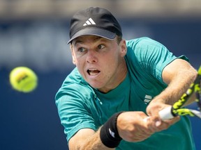 Alex Michelsen of the United States lunges for a backhand on his way to defeating Learner Tien of the United States at the National Bank Open in Toronto, on Saturday, Aug. 2, 2025.