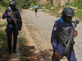 Police officers patrol the area near the Saint-Helene orphanage in the Kenscoff neighbourhood of Port-au-Prince, Haiti, Monday, Aug. 4, 2025.