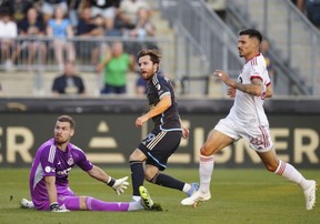 Philadelphia Union's Indiana Vassilev, centre, watches his goal past Toronto FC goalkeeper Luka Gavran, left, and Raoul Petretta, right, during the first half of an MLS soccer match, Saturday, Aug. 9, 2025, in Chester, Pa.