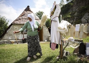 A Bosnian Muslim woman prepares wool