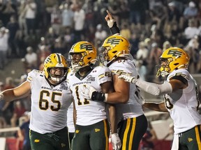 Edmonton Elks' Kaion Julien-Grant (11) celebrates with teammates after he scored during second half CFL action against the Montreal Alouettes in Montreal on Friday, Aug. 8, 2025.