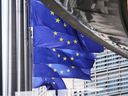 European Union flags flap in the wind outside EU headquarters in Brussels, Thursday, Aug. 21, 2025.