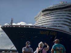 Tourists take pictures after exiting Carnival's Mardi Gras cruise ship, docked in the bay of San Juan, Puerto Rico, Tuesday, Aug. 3, 2021, marking the first time a cruise ship visits the U.S. territory since the COVID-19 pandemic began.