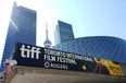 A sign for the 2024 Toronto International Film Festival Festival is pictured in front of the CN Tower on the opening day of the festival, Thursday, Sept. 5, 2024, in Toronto.