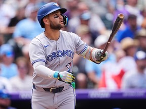 Blue Jays' Bo Bichette follows the flight of his three-run home run off Colorado Rockies pitcher Kyle Freeland in the third inning on Wednesday, Aug. 6, 2025, in Denver.