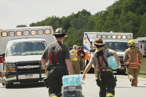 Rescue personnel work the scene of a tour bus that crashed and rolled over on the New York State Thruway near Pembroke, N.Y., Friday, Aug. 22, 2025. LIBBY MARCH/THE ASSOCIATED PRESS