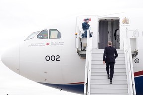 Prime Minister Mark Carney boards a government plane on Monday, May 5, 2025.