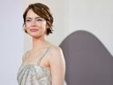Emma Stone poses on the red carpet before the premiere of “Bugonia.”