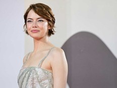 Emma Stone poses on the red carpet before the premiere of “Bugonia.”