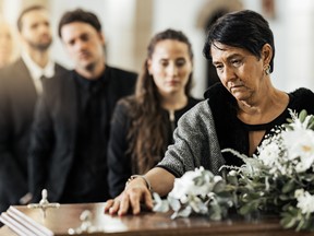 Funeral, death and coffin in church or Christian family gathering together for support. Religion, sad people and mourning loss or religious catholic men and women grief in church service over casket