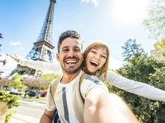 Happy couple of tourists taking selfie picture in front of Eiffel Tower in Paris, France - Travel and summer vacation life style concept