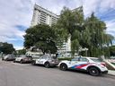 Toronto Police cruisers sit outside the Trillium apartment, at Woodbine Ave. and O’Connor Dr., on Wednesday, Aug. 13, 2025, the day after a man was stabbed to death.