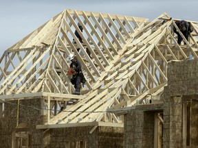 Framers work on a new home build in Aurora, Ont. Wednesday May 14, 2025.