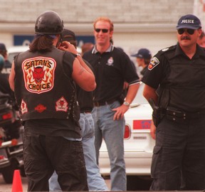 A Satan's Choice member waits to talk to police at a checkpoint before their summer party north of Scugog in the earlly 2000s. JACK BOLAND/TORONTO SUN FILES