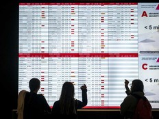 Passengers looking at a departures board in Montreal during the Air Canada flight attendants’ strike on Monday, Aug. 18, 2025.