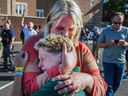 A parent hugs her son during an active shooter situation at the Annunciation Church in Minneapolis, Minn., Wednesday, Aug. 27, 2025.