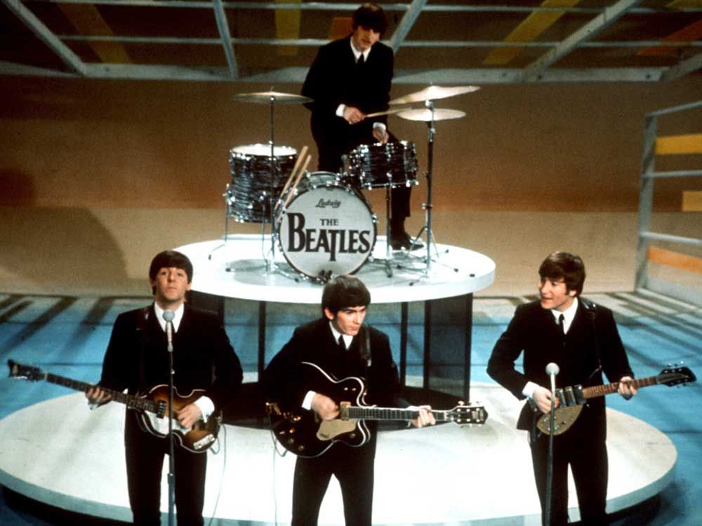 The Beatles, foreground from left, Paul McCartney, George Harrison, John Lennon and Ringo Starr, on drums, perform on the CBS "Ed Sullivan Show" in New York, Feb. 9, 1964.