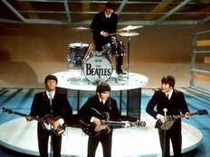 The Beatles, foreground from left, Paul McCartney, George Harrison, John Lennon and Ringo Starr, on drums, perform on the CBS "Ed Sullivan Show" in New York, Feb. 9, 1964.