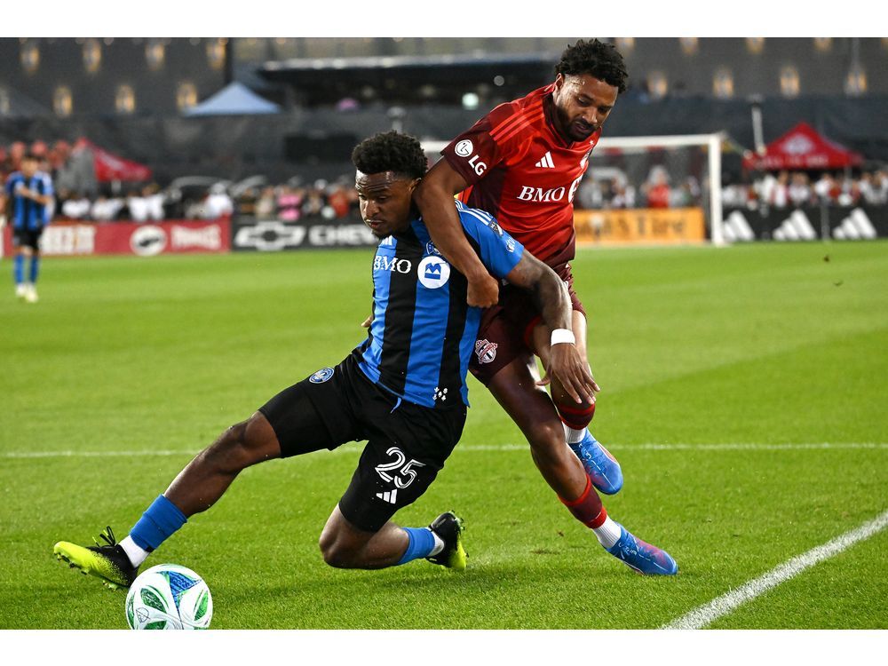 Toronto FC's Kosi Thompson, right, tackles CF Montreal's Dante Sealy