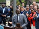 Chicago Mayor Brandon Johnson, center, at a news conference with Illinois Gov. JB Pritzker, right.