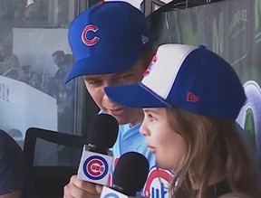 Hayden Christensen and his daughter Briar Rose sing at the Chicago Cubs game.