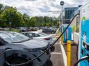 Several electric vehicles are plugged in and using the charging ports outside the Port Moody Recreation Complex on July 3, 2025, in Port Moody, B.C.