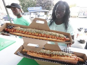 Awok shows off one of the offerings at this year’s CNE: A $55 two-foot hotdog with all the fixing. On Aug. 13, 2025. (Jack Boland, Toronto Sun