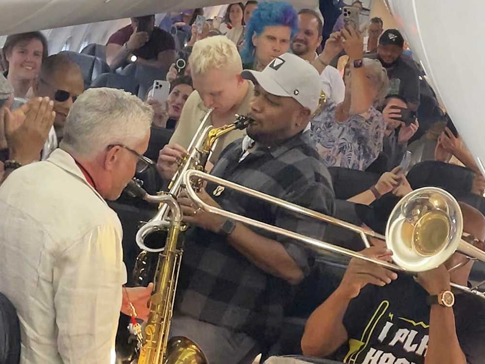 In this screenshot taken from video provided by Bridgeway Entertainment Inc, jazz musicians perform for their fellow passengers after their flight had suffered multiple delays on Monday, Aug. 11, 2025, in Boise, Idaho.