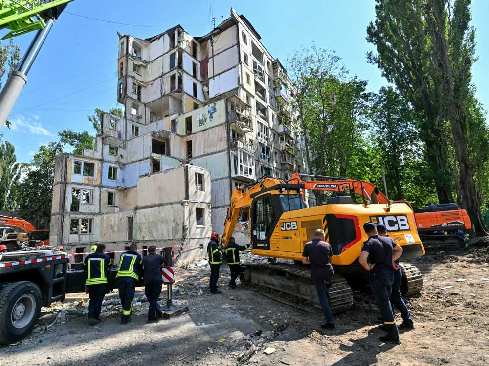 Rescuers work outside a residential building in Kyiv on August 1, 2025, partially destroyed following a Russian missile strike morning on July 31, 2025, amid Russian invasion in Ukraine.