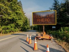 A sign warns of a wildfire burning on Mount Underwood near Port Alberni, on Vancouver Island, B.C., on Aug. 12, 2025.