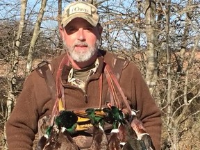 Asher Watkins with dead fowl slung around his neck.
