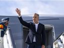 Prime Minister Mark Carney waves as he boards a government plane to head home from Riga, Latvia on Wednesday, Aug. 27, 2025.