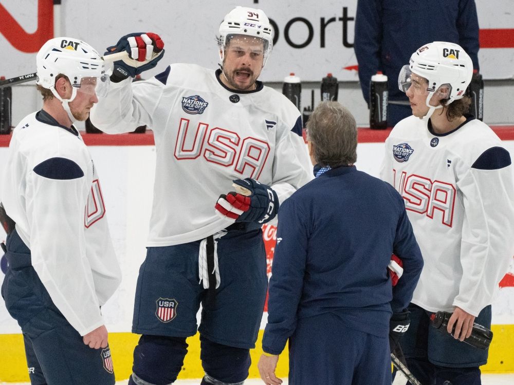 USA players Austin Matthews (center), Jack Eichel (left) and Jack Hughes (right) speak with the coaching staff during a Four Nations match.
