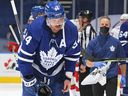 Auston Matthews of the Toronto Maple Leafs is injured late in the game against the Carolina Hurricanes during a game in 2022.