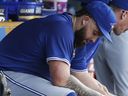 Toronto Blue Jays pitcher Alec Manoah sits on the bench after being suspended last year.