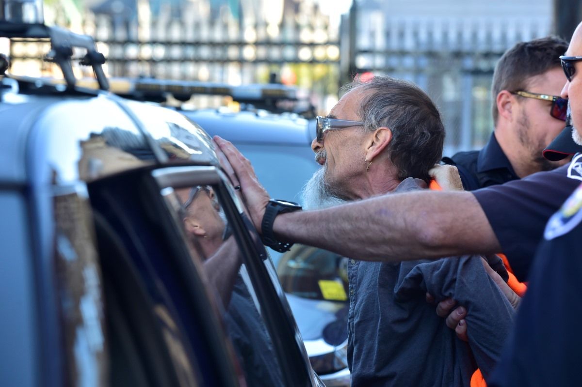 Ottawa police arrest a protester outside of West Block at Parliament Hill in Ottawa on Monday,  Sept. 15, 2025.