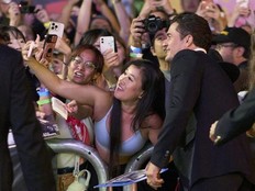 English actor Orlando Bloom takes pictures with fans as he arrives for the premiere of "The Cut" during the Toronto International Film Festival at the Princess of Wales Theatre in Toronto on September 5, 2024. (Photo by GEOFF ROBINS/AFP via Getty Images)