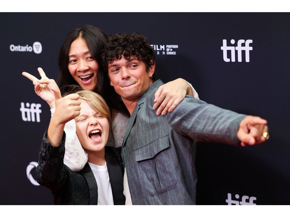 Chinese filmmaker Chloe Zhao (centre) poses with brothers and British actors Jacobi Jupe and Noah Jupe during the premiere of "Hamnet" at the Princess of Wales Theatre at the Toronto International Film Festival in Toronto, on Sept. 7, 2025.
